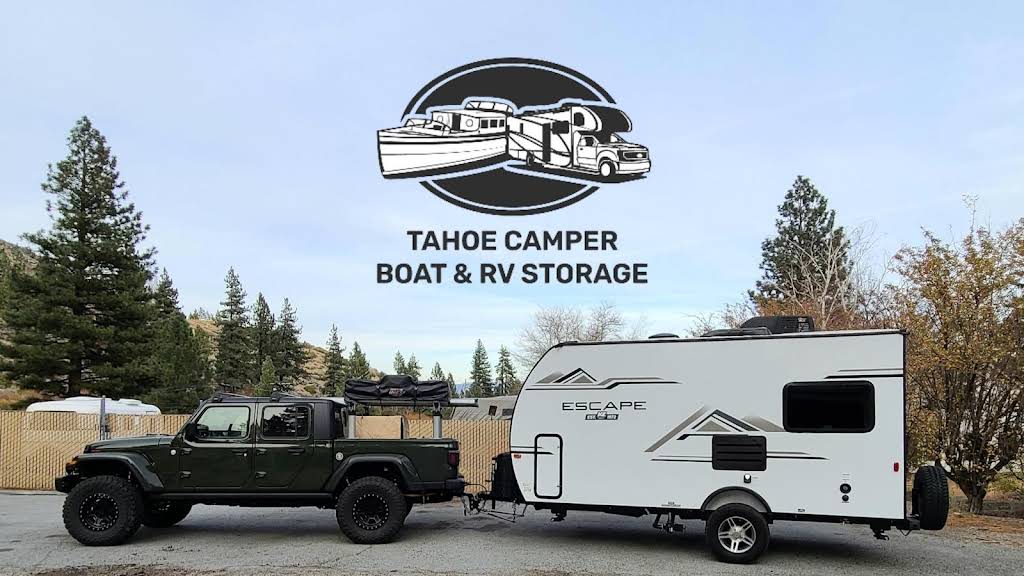 Jeep Gladiator towing an Escape travel trailer at Tahoe Camper Storage, with the business logo above
